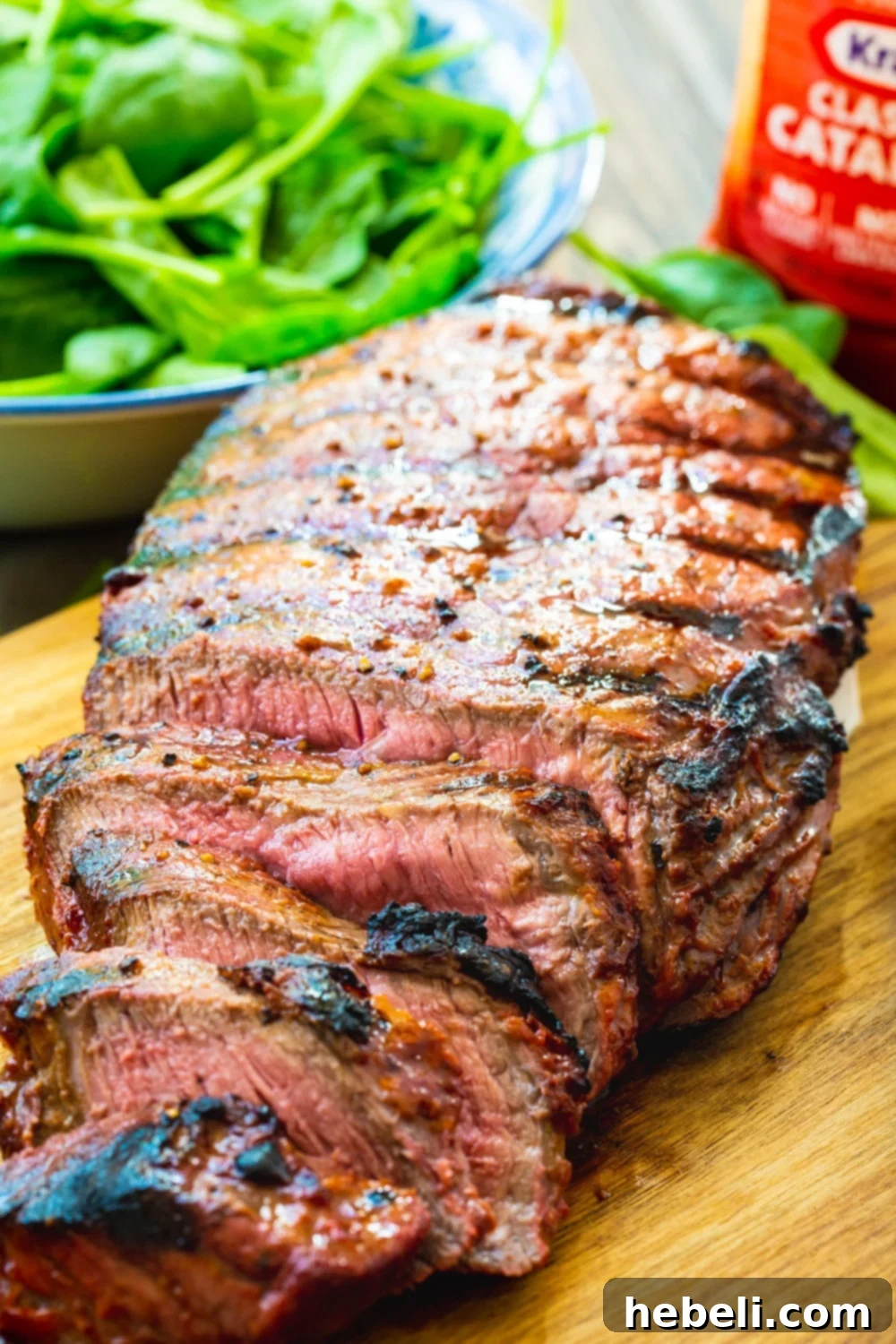 Close-up of thin slices of Catalina London Broil, showing the juicy interior and flavorful crust.