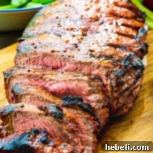 Catalina London Broil on a wood cutting board with slices cut.