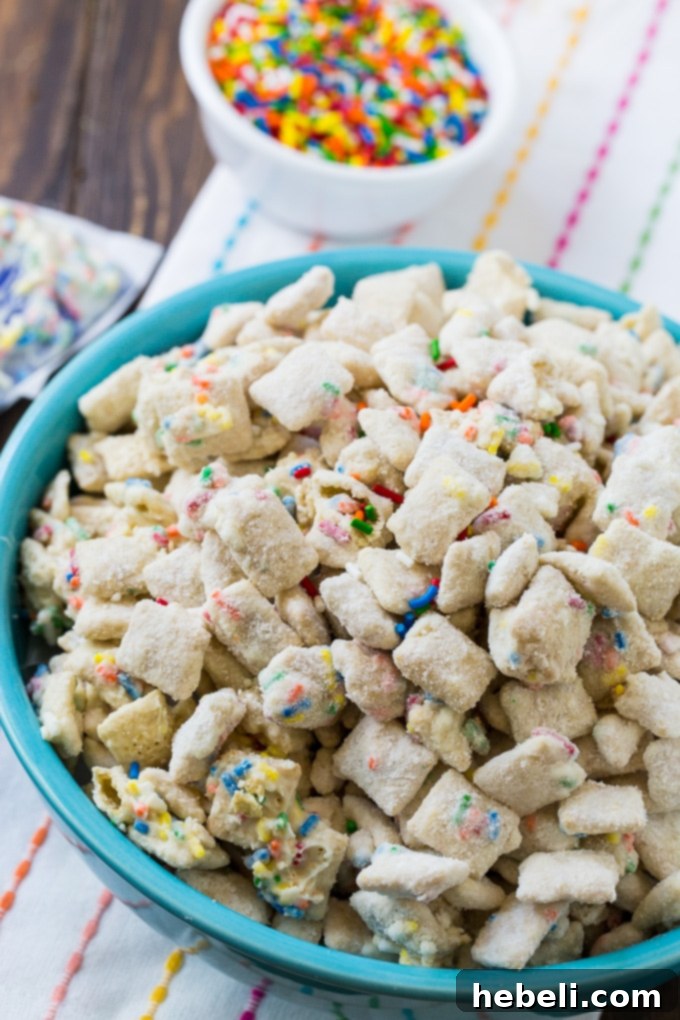 Close-up of Cake Batter Muddy Buddies showing white chocolate and sprinkles