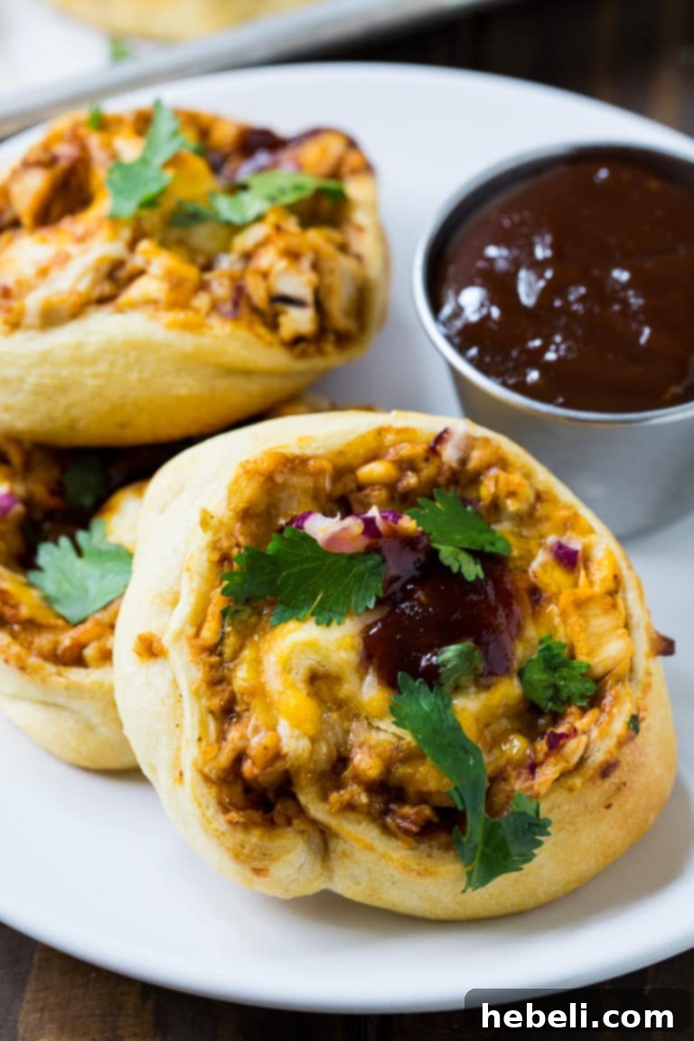 A plate of freshly baked BBQ Chicken Crescent Pinwheels, ready to be served, showcasing the golden crust and savory filling.