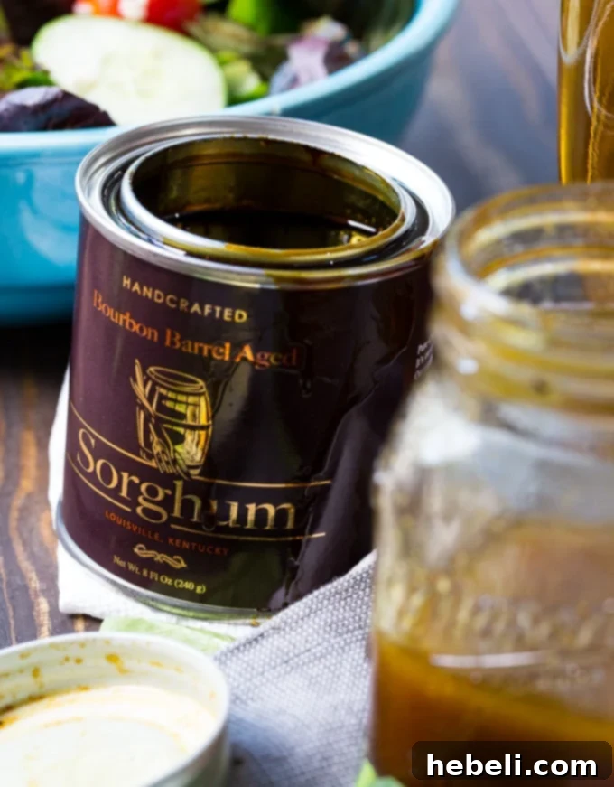 Golden Bourbon Sorghum Dressing 4 A close-up of a vibrant salad drizzled with homemade Bourbon Sorghum Vinaigrette, highlighting its appealing texture and rich color.