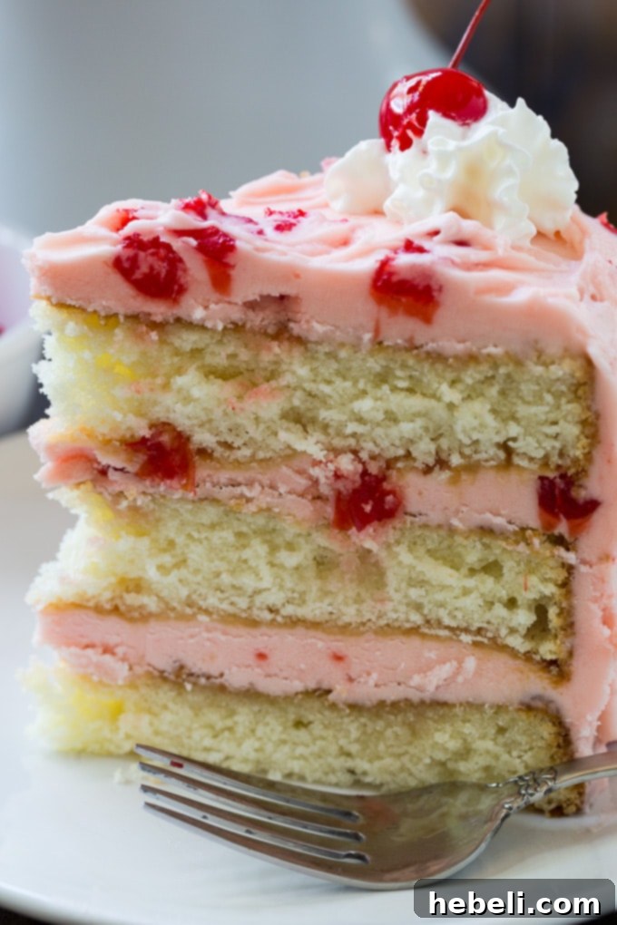 Layers of White Cake with Maraschino Cherry Frosting stacked beautifully