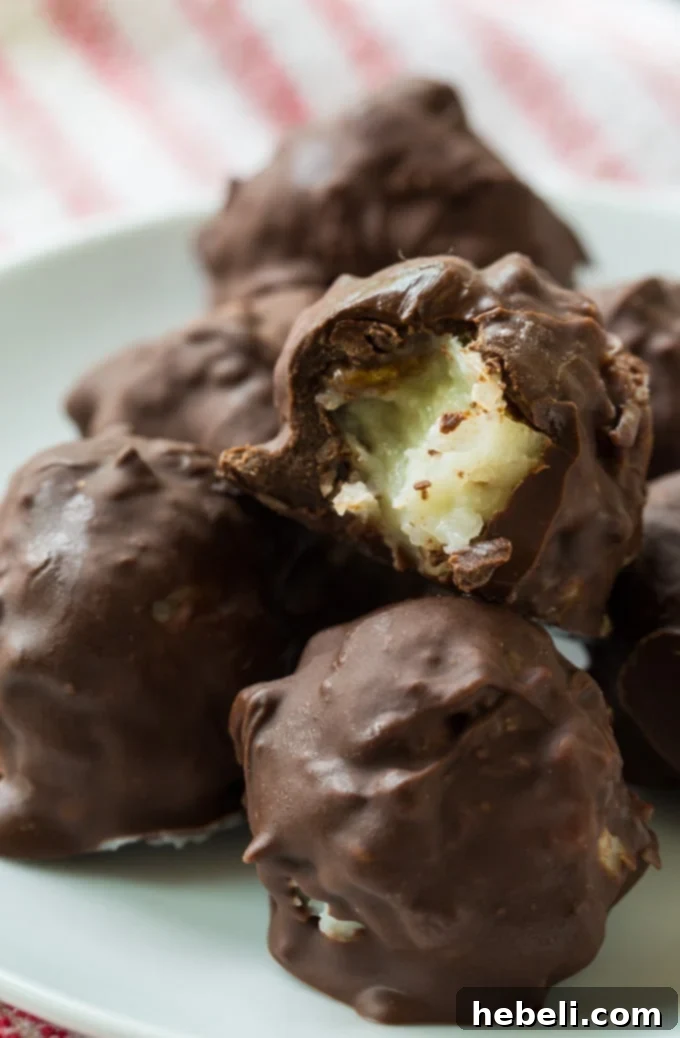 A plate full of delectable, old-fashioned Martha Washington Candies, with their glossy chocolate coating and perfect round shape, ready to be enjoyed.