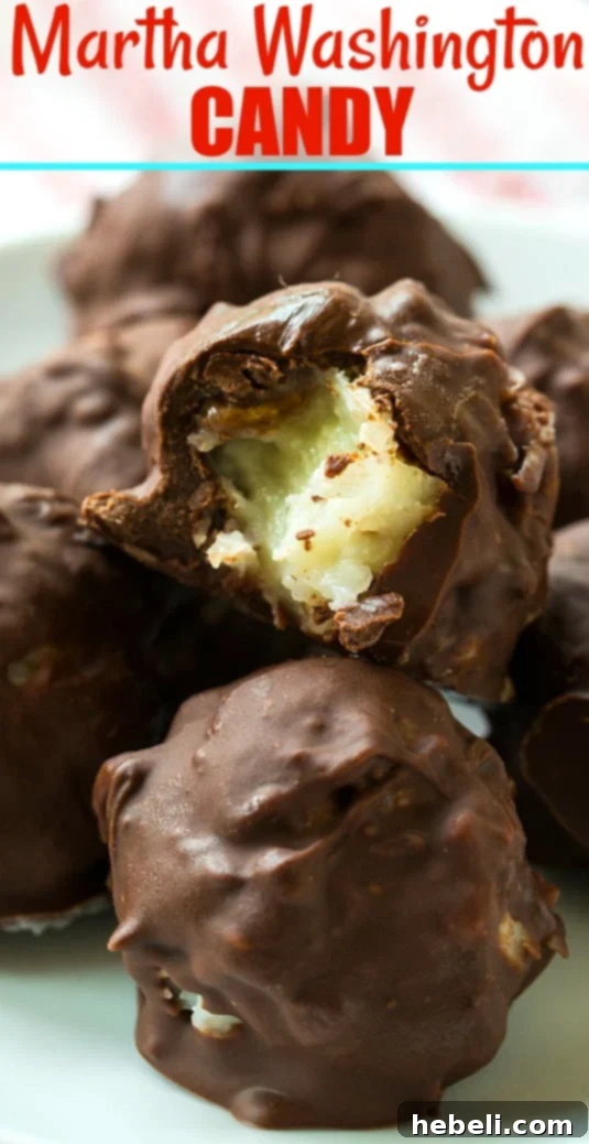 A close-up of a halved Martha Washington Candy, perfectly showcasing its soft, white coconut and pecan filling beneath a smooth chocolate coating.