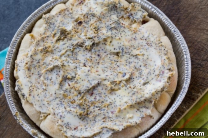 Close-up of Poppy Seed Sausage Rolls showing the golden crust and poppy seed topping.