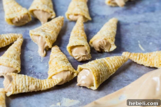 Chocolate Peanut Butter Bugle Bliss 3 Chocolate Dipped Peanut Butter Bugles recipe - A batch of finished bugles on a baking sheet