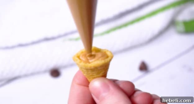 Filling a Bugle with peanut butter mixture.