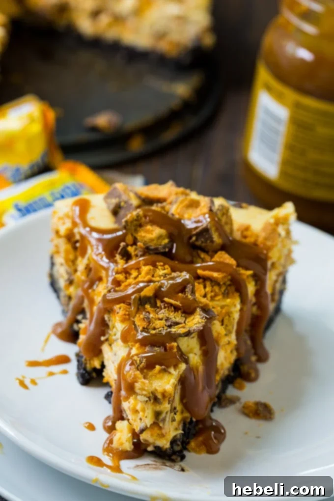 Butterfinger Crunch Cheesecake 3 Butterfinger Cheesecake with Oreo crust on a wooden board