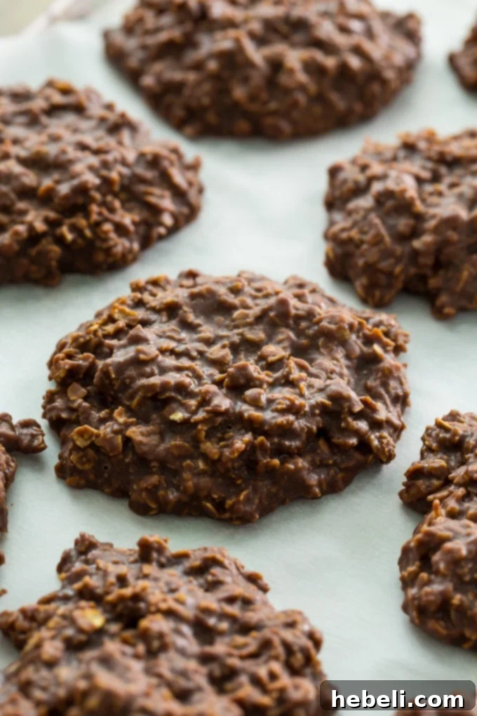 Delicious No-bake Chocolate Oatmeal Cookies on parchment paper, ready to be enjoyed.