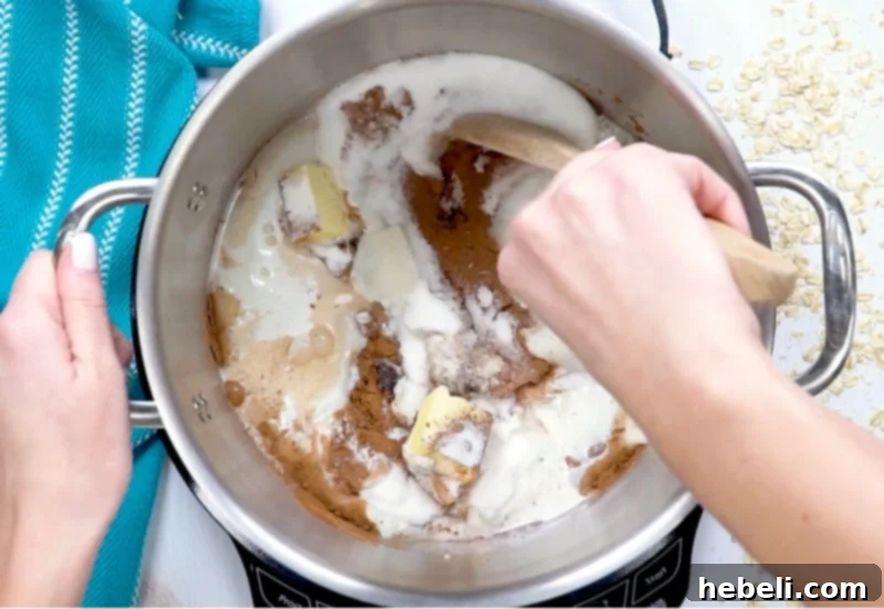 Ingredients for no-bake chocolate oatmeal cookies simmering in a saucepan.