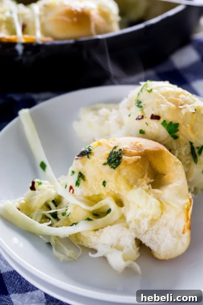 Close-up of baked Cheesy Garlic Skillet Rolls, golden and gooey