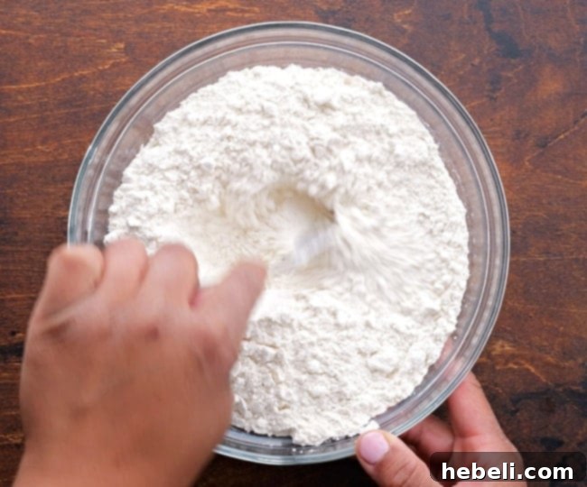 Mixing flour and salt in a bowl, a foundational step for perfectly blended dry ingredients.
