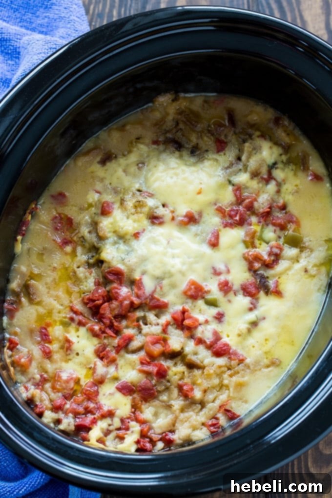 Slow Cooker Cheesy Chicken and Stuffing Dinner 2 Crock Pot Cheesy Stuffing Chicken, a hearty slow cooker meal with melted Swiss cheese and golden stuffing.