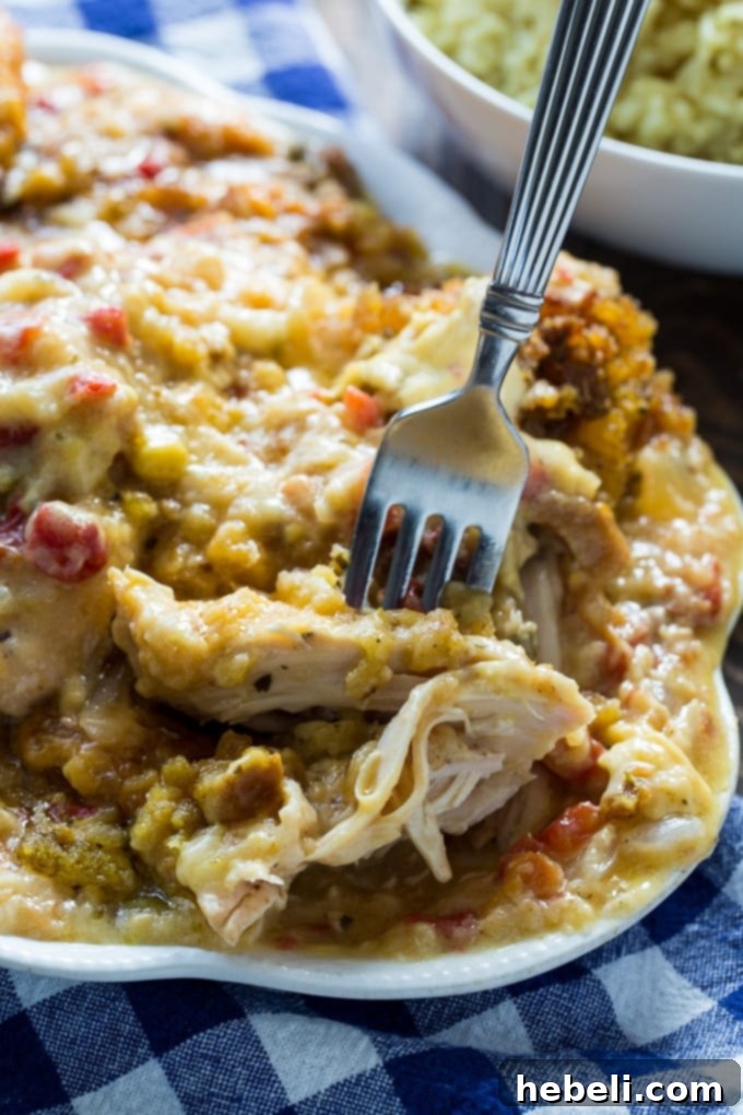 Slow Cooker Cheesy Chicken and Stuffing Dinner 5 A serving of Crock Pot Cheesy Stuffing Chicken being scooped from the slow cooker.