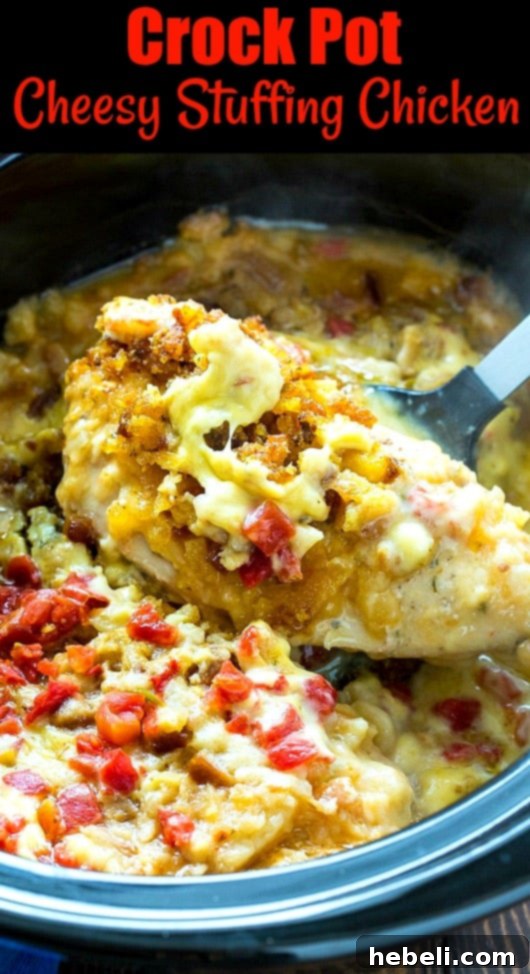 Slow Cooker Cheesy Chicken and Stuffing Dinner 7 A spatula lifting a piece of tender, cheesy chicken from a slow cooker, ready to be served.