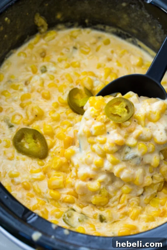 Slow Cooker Jalapeno Creamed Corn simmering in a crock pot