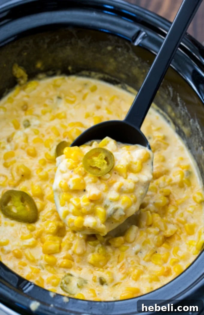 Close-up of Crock Pot Jalapeno Creamed Corn, showing the creamy texture and diced peppers