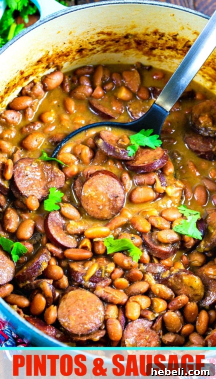 Close-up of Pintos and Sausage in a blue Dutch oven, showing rich texture.