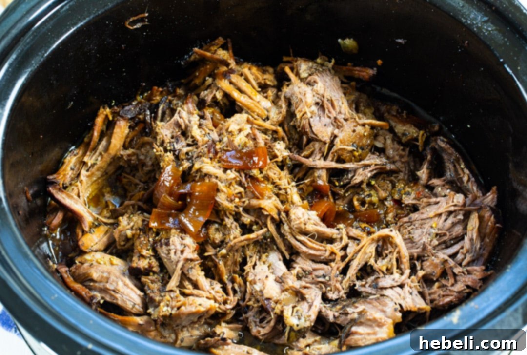 Shredded beef in slow cooker.