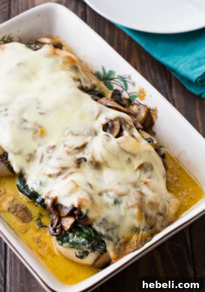 Creamed Spinach and Mushroom Smothered Chicken – a dish with tender chicken, creamy spinach, savory mushrooms, and melted cheese