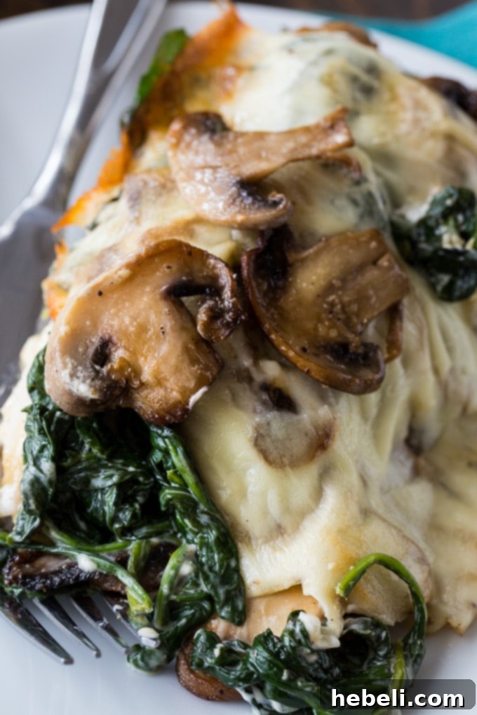 Completed Creamed Spinach and Mushroom Smothered Chicken, baked to golden perfection with melted mozzarella