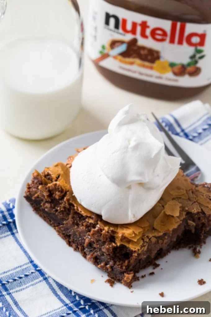 A large pan of Nutella Gooey Butter Cake, freshly baked and cooling, ready to be sliced.