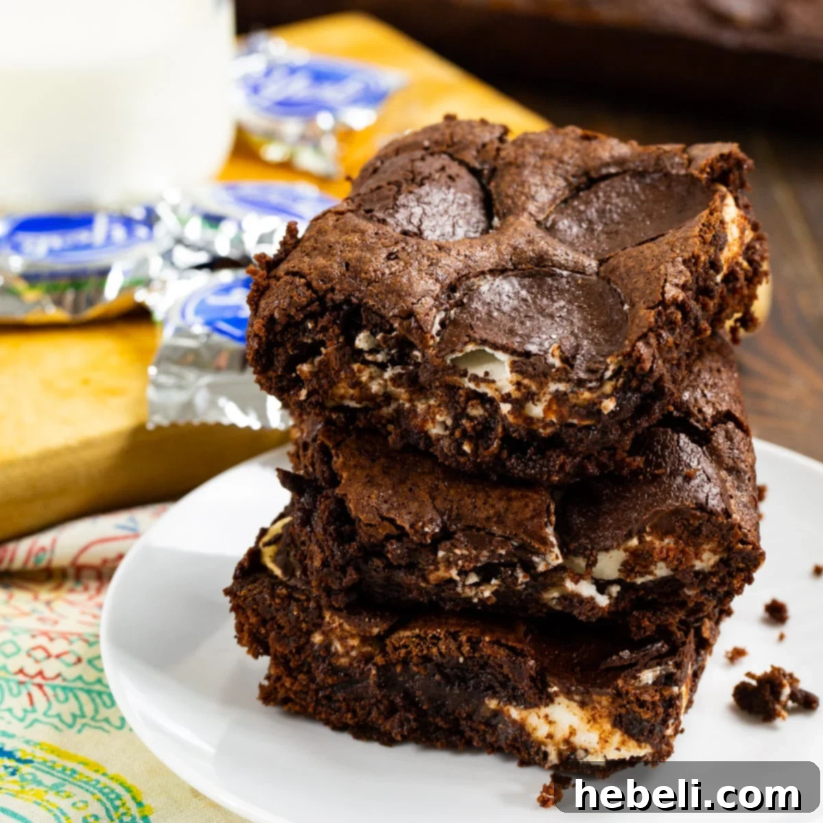 Three Peppermint Brownies stacked on top of each other, showcasing their fudgy texture and mint filling.
