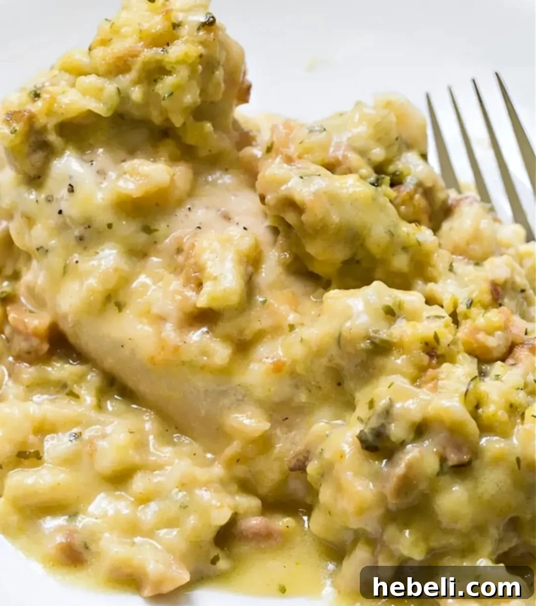Swiss Bliss Instant Pot Chicken 2 A serving of Instant Pot Swiss Chicken dished up on a plate, showcasing the chicken, melted Swiss cheese, and savory stuffing.