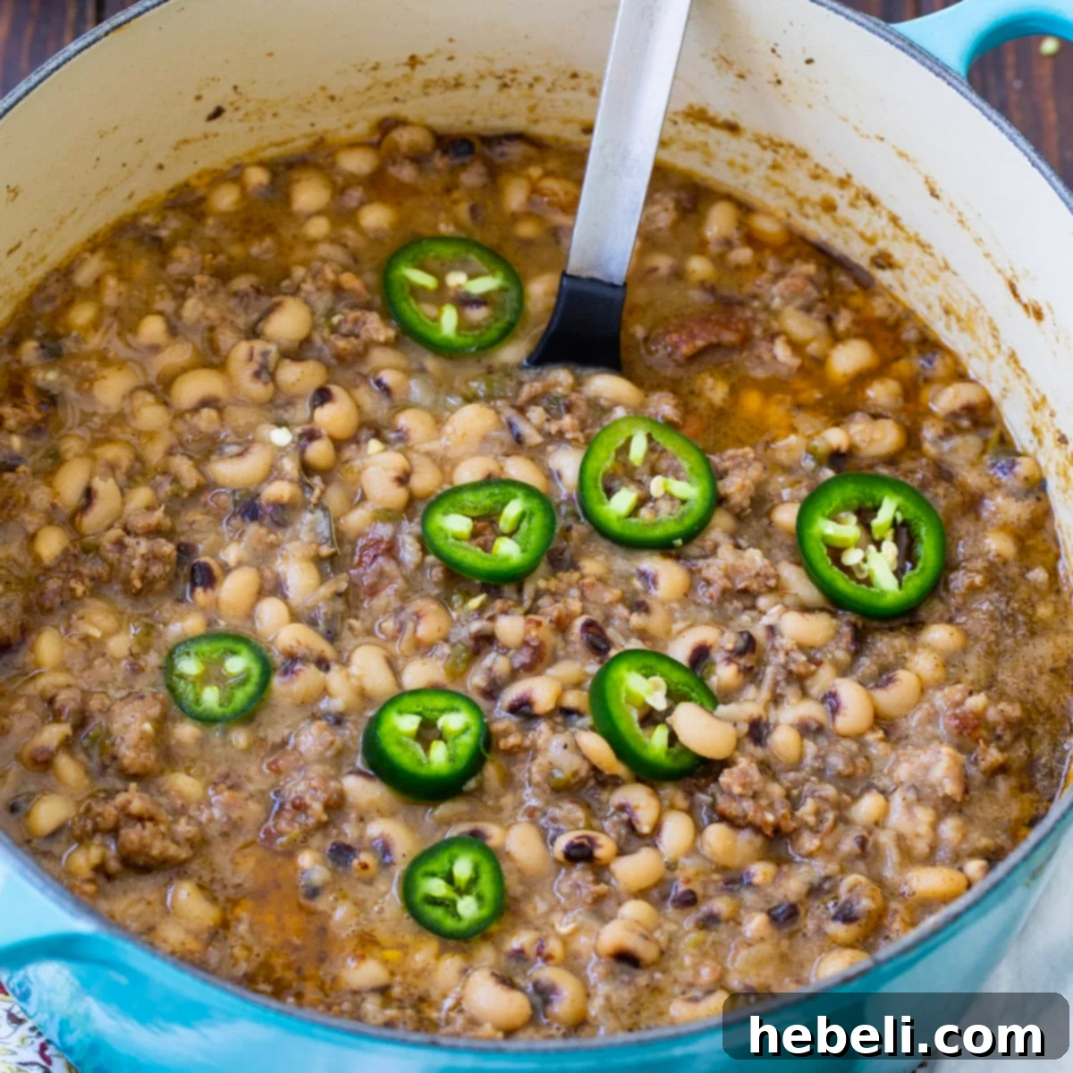 Zesty Black-Eyed Peas 2 A hearty pot of Black-Eyed Peas with Jalapeno simmering in a Dutch oven, showcasing its rich, meaty, and spicy texture.