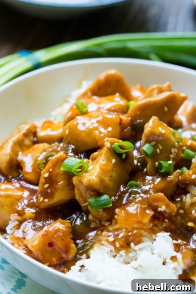 A vibrant and appealing presentation of Instant Pot Honey Sesame Chicken served over white rice, topped with fresh green onions and sesame seeds, ready for a satisfying family dinner.