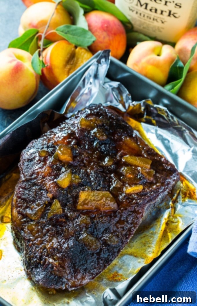 Slow-Roasted Beef Brisket with Bourbon Peach Glaze 3 Close-up of Oven Roasted Brisket, scored with a crosshatch pattern and glazed