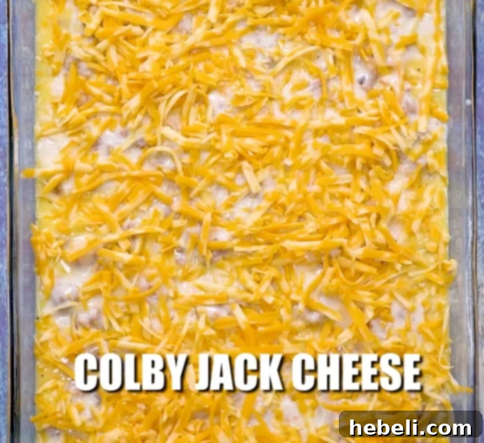 The last layer of shredded cheese sprinkled generously over the top of the casserole.