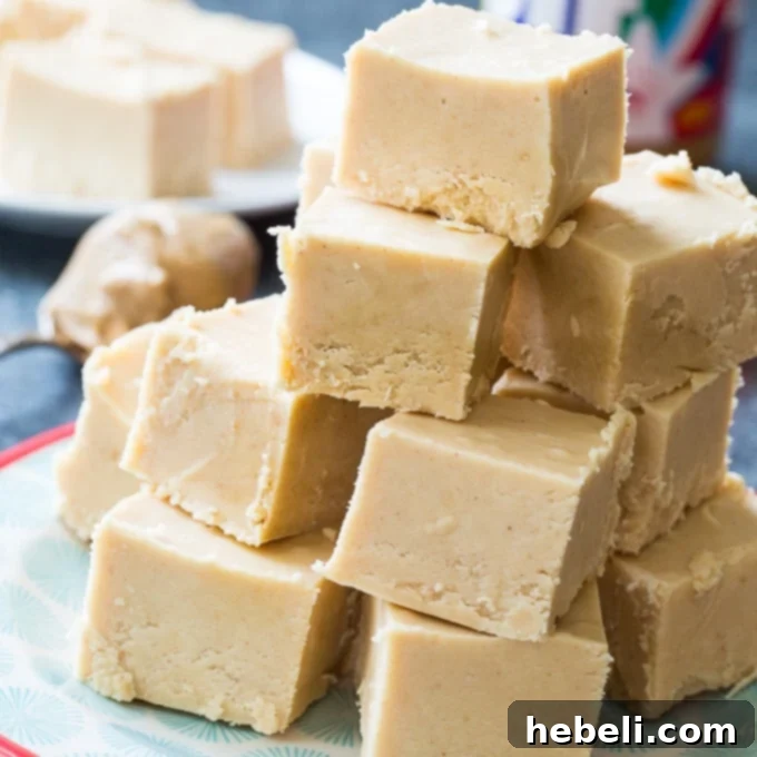Easy Peanut Butter Fudge, perfectly cut into squares on a white plate, ready to be served or gifted