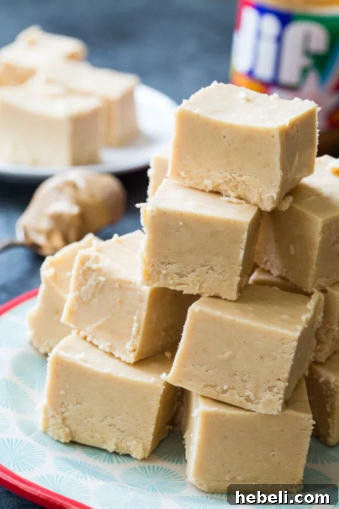 Fudge squares elegantly stacked on a rustic wooden board, ready for presentation or a sweet indulgence