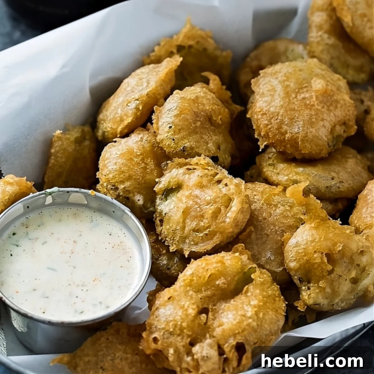 Fried Pickles in a tray with spicy ranch dipping sauce.