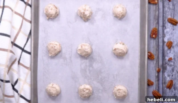 Bourbon Balls shaped and placed on a baking sheet, ready for chilling.