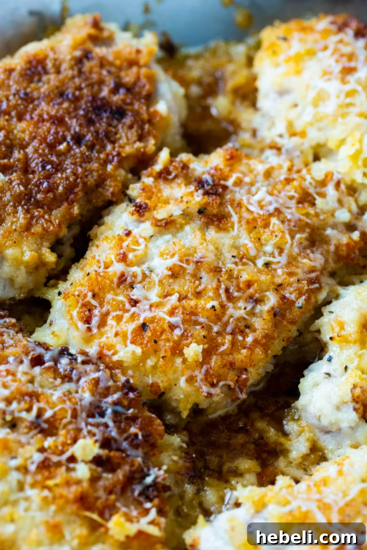 Close-up of perfectly cooked Buttermilk Parmesan Pork Chops with a golden crust.