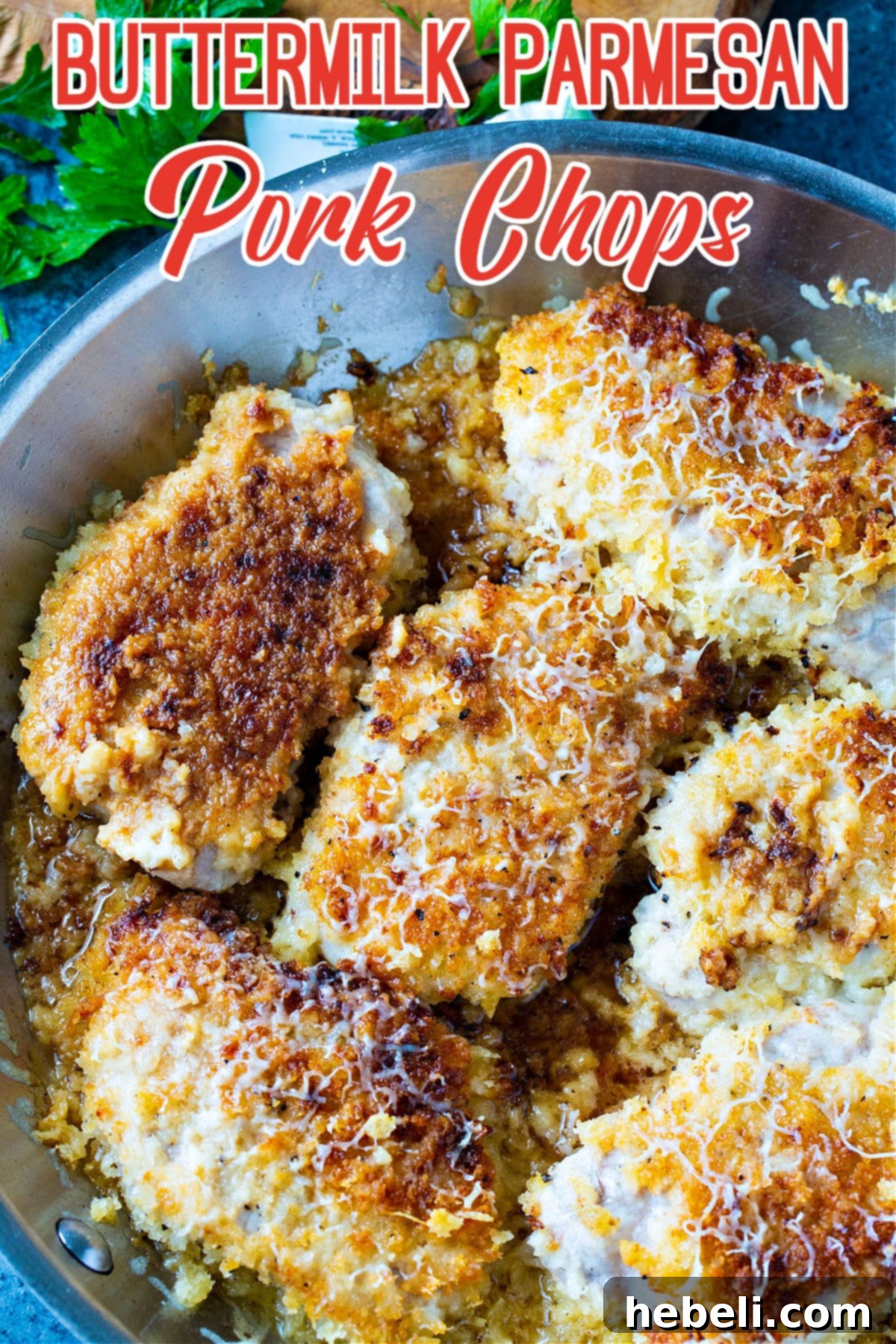 Buttermilk Parmesan Pork Chops ready to be served from the skillet.