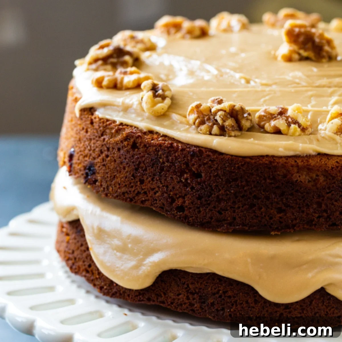 A stunning Kentucky Blackberry Jam Cake, perfectly baked and covered in luscious caramel icing, presented elegantly on a cake stand.