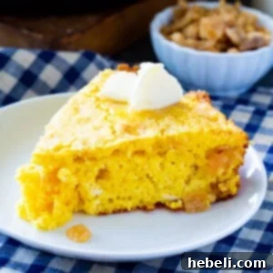 Slice of Crackling Cornbread topped with butter.