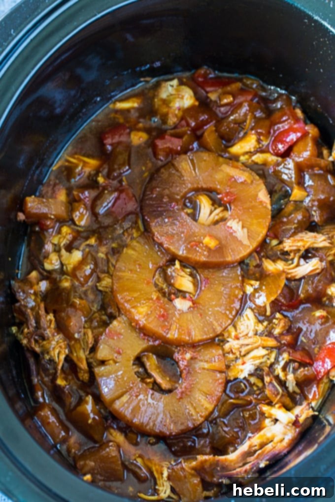 Tropical Sticky Slow Cooker Chicken 3 Close-up of Crock Pot Sticky Hawaiian Chicken in the slow cooker, highlighting the tender chicken and rich sauce.