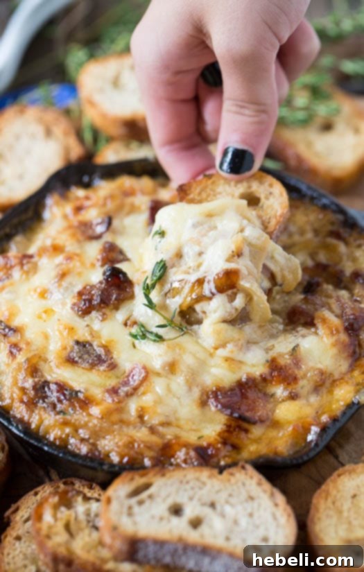 Showstopping Party Dips 3 A bowl of hot caramelized onion dip with bacon and Gruyere, garnished with fresh chives, ready to be served.