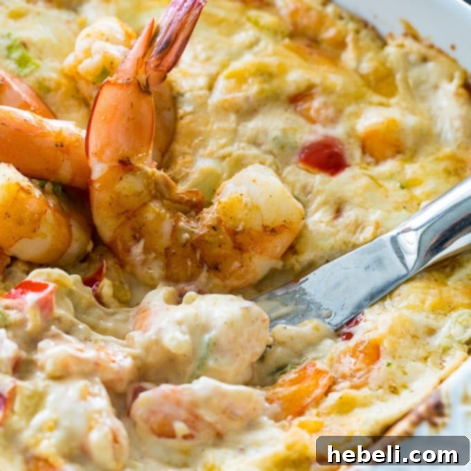 Showstopping Party Dips 5 A bowl of creamy spicy shrimp dip, garnished with fresh herbs and served with crackers, perfect for a game day.