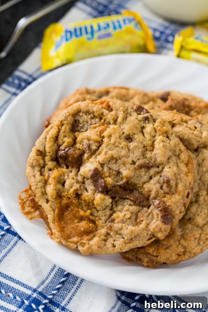 Freshly baked Butterfinger Cookies with a glass of milk, ready to be enjoyed