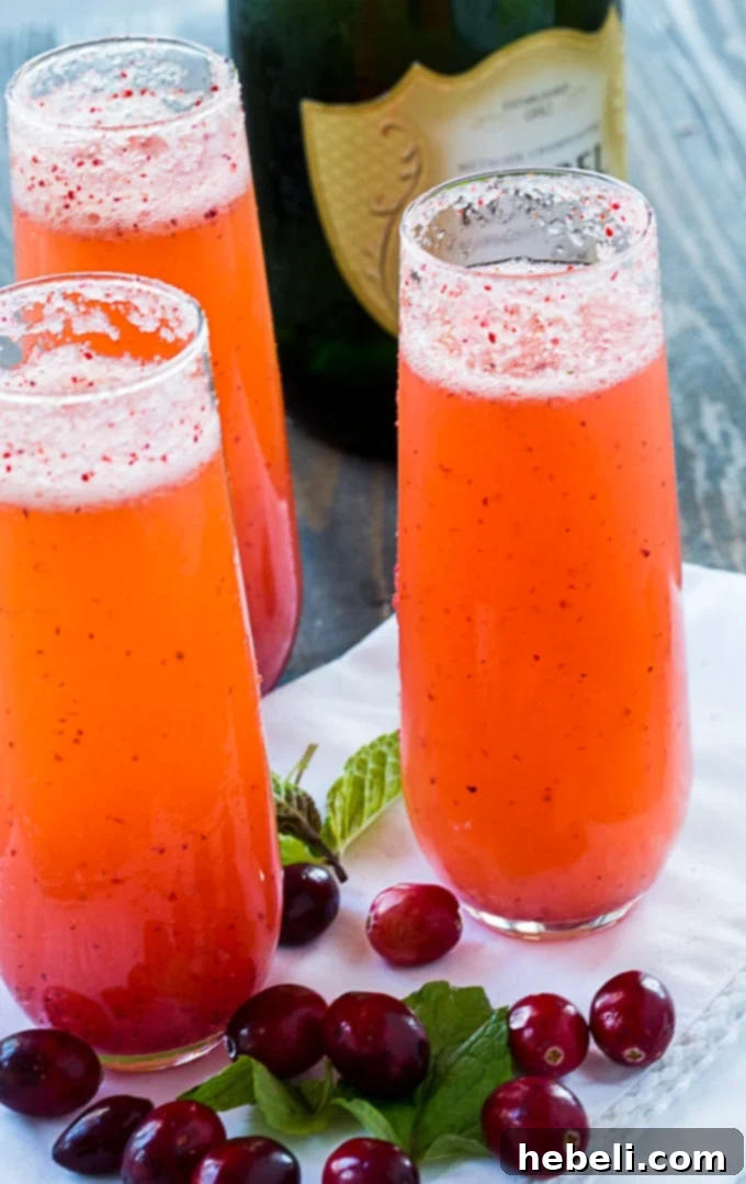 Cranberry Orange Mimosas in champagne flutes, ready to serve