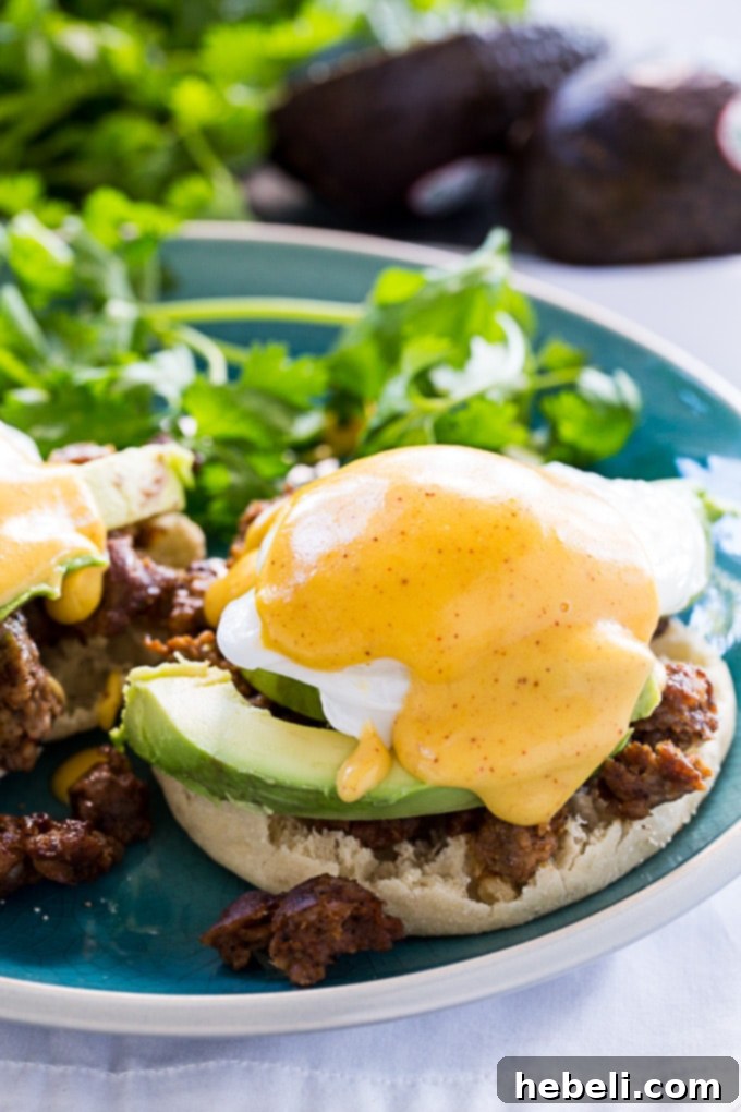 Huevos Benedictos 3 Mexican Eggs Benedict with chorizo and avocado slices