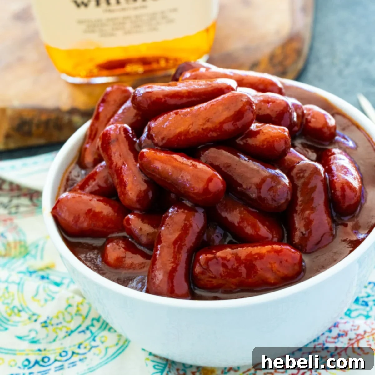 Sticky Bourbon Smokies 2 A bowl filled with glistening Crock Pot Bourbon Smokies, ready to be served as an appetizer.