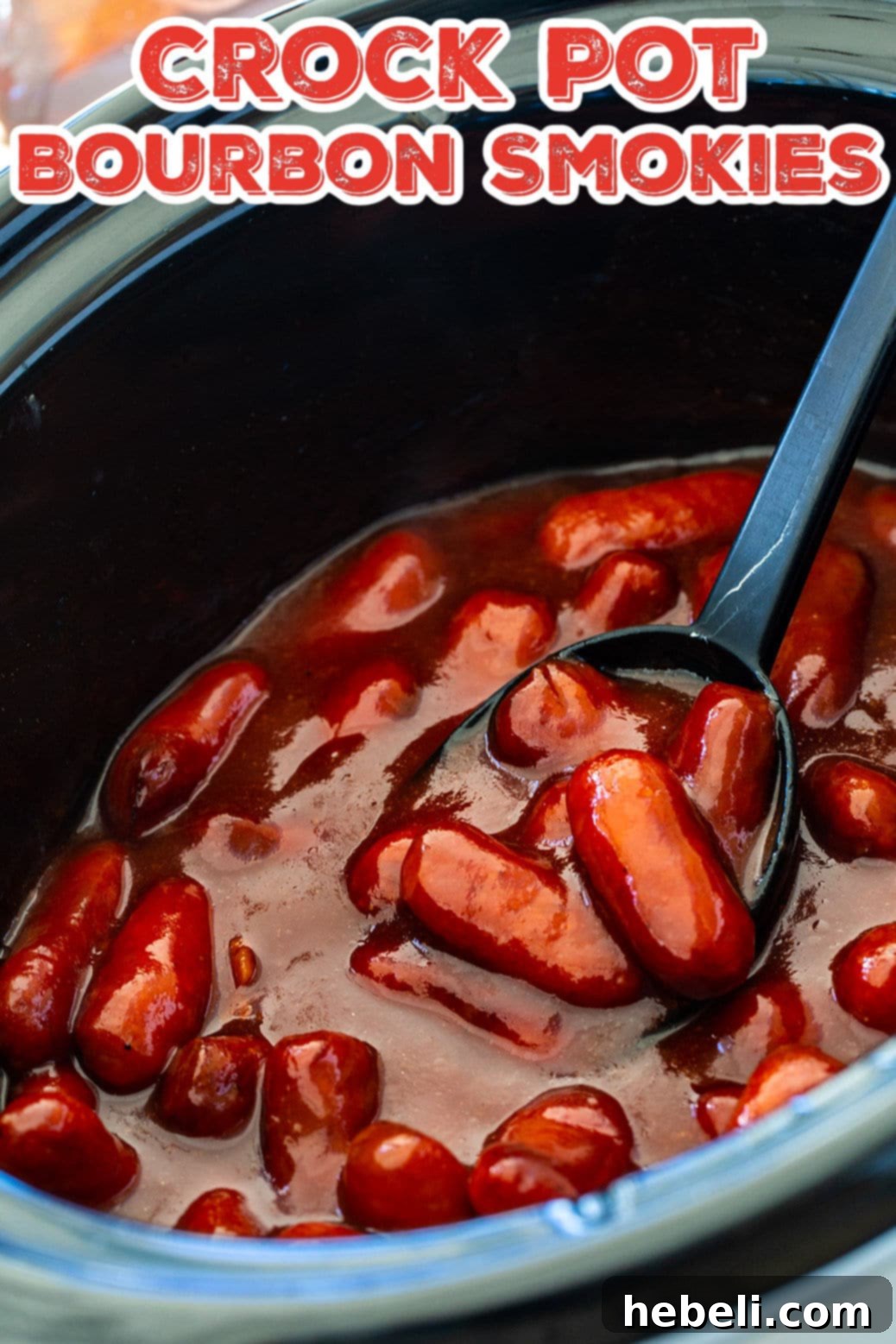 Sticky Bourbon Smokies 4 Crock Pot Bourbon Smokies simmering in a slow cooker, coated in a rich, dark sauce.