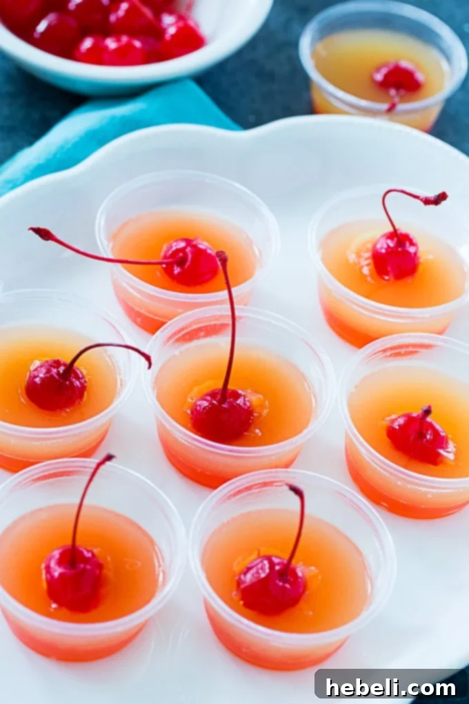 Caramelized Pineapple Cake Jell-O Shots 4 A festive arrangement of Pineapple Upside Down Jello Shots on a white platter, ready for serving.