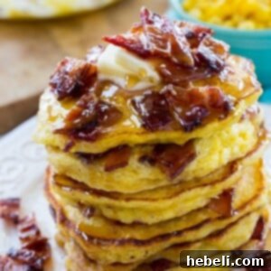 A close-up of a perfectly cooked Sweet Corn and Candied Bacon Pancake, showcasing the corn texture and bacon pieces within.